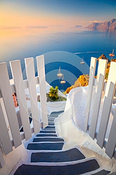 Gateway to rest. Santorini, Greece. White architecture, open doors and steps to the blue sea of Santorini island, Oia