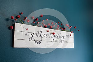 We gather together and give thanks sign on the wall
