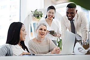 Gathered around to discuss ideas. a group of diverse businesspeople having an informal meeting in their office.