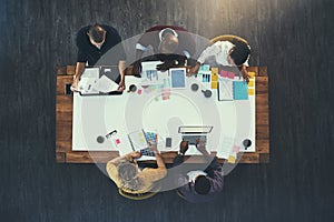 Gathered to make business great. High angle shot of a group of businesspeople having a meeting in a modern office.