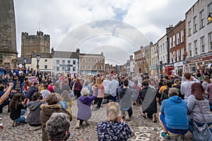 A gathering of protesters kneel at a Black Lives Matter protest in Richmond, North Yorkshire, with Richmond Castle in the