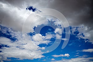 Gathering storm clouds in a blue sky