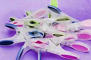 gathering of washing pegs on lilac surface