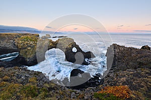 Gatklettur at autumn sunset, an Arch Rock in west Iceland