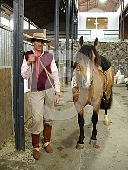 Gaucho with his horse with the characteristic clothing in Argentina
