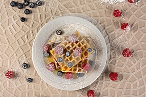 Gaufre with wild berries on a plate