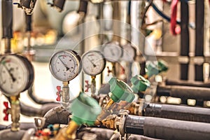 Gauge closeup, pressure measurement . Pipes and valves in the industrial enterprise