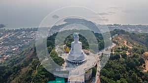 Gautama Buddha statue on the hill in Phuket town. Aerial view. Asia