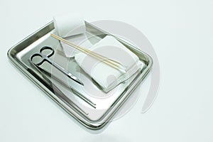 Gauze, Orthopedic Bandage,Cotton Swab, Tissue Forceps and Scissors on the Medical Stainless Steel Tray for Wound Dressing