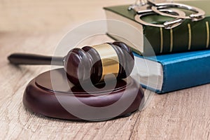 Gavel with book and handcuff on desk