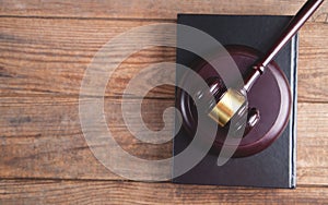 Gavel with book on a wood surface