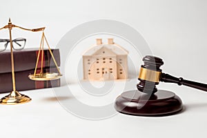 Gavel, books, scales of justice with house model for lawyer courtroom decoration object.