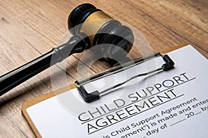 A gavel on a child support agreement document.