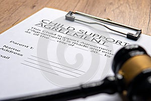 A gavel on a child support agreement document.
