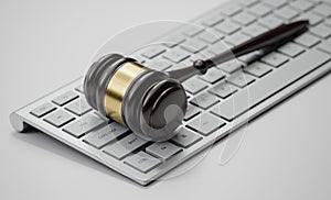 Gavel at the computer keyboard: Legal and law concept. Wooden hammer of justice and order