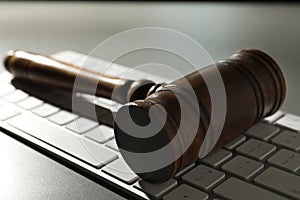 Gavel and computer keyboard on table. Cyber crime