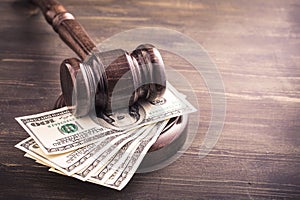 Gavel and dollars banknotes on table