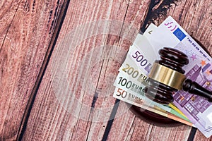 Gavel and euros money on wooden table.