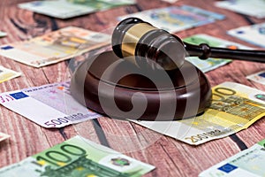 Gavel and euros money on wooden table photo
