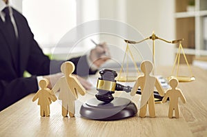 Gavel and family figures on judge's table illustrating concept of divorce and child custody