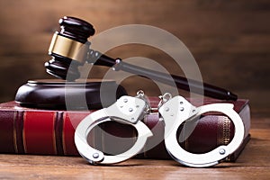 Gavel And Handcuffs On Law Book photo