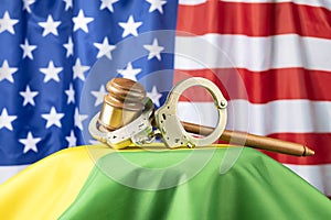 Gavel and handcuffs on rainbow flag