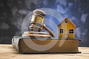 Gavel with house model on book