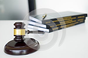 gavel Judge hammer with legal book on brown wooden desk with cop