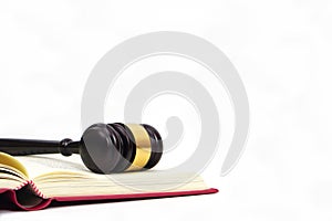Gavel of judge placed on law book on white background. Lawyer, legal and judiciary concept.