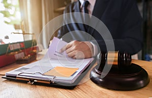 Gavel of Justice with scales and lawyer working on a laptop. Legal law, advice and justice concept.