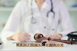 Gavel lies on wooden blocks put in words Medical Error