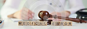 Gavel lies on wooden blocks put in words Medical Error