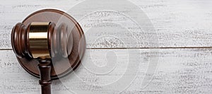 Gavel and pedestal on a white wood background with copy space