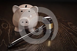 Gavel and Piggy Bank on Table