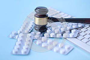 Gavel and pills on a blue background. Medical crime. rising prices for medicines.
