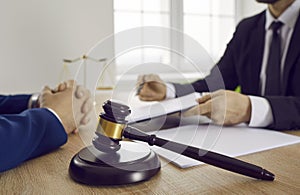 Gavel placed on a desk in the office of a lawyer providing legal services to a client