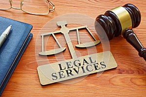 Gavel and scale model with inscription legal services.