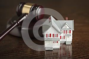 Gavel and Small Model House on Table