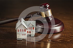 Gavel and Small Model House on Table