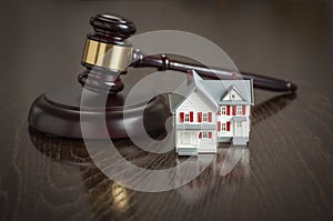 Gavel and Small Model House on Table