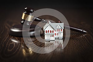 Gavel and Small Model House on Table