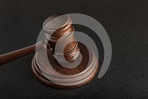 Gavel and sounding block on black background close up. Justice and law concept