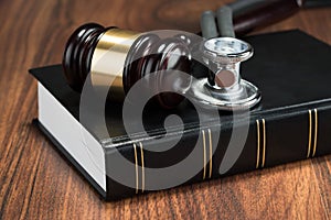 Gavel and stethoscope on book