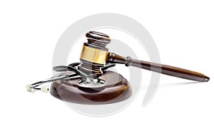 Gavel with stethoscope on stand. Isolated on white. Medical law concept