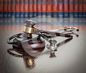 Gavel and Stethoscope on Table With Law Books In Background