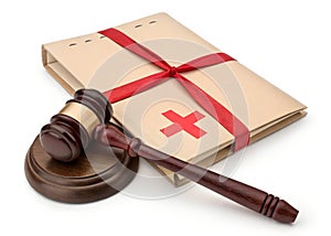 A gavel striking a Medicaid folder with red tape around it photo
