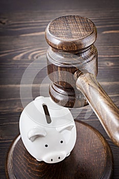 Gavel under small piggy bank