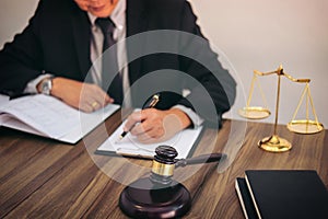 Gavel on wooden table and Lawyer or Judge working with agreement