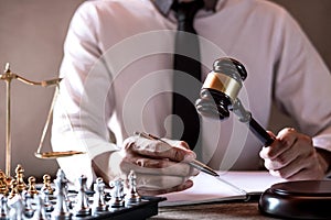 Gavel on wooden table and Lawyer or Judge working with agreement in Courtroom theme, Justice and Law concept