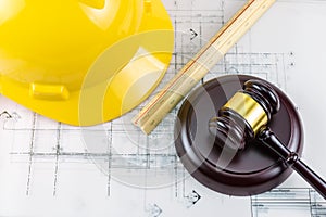 Gavel and yellow safety helmet